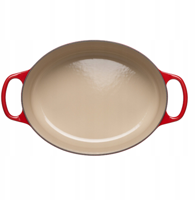 Tenxhere ovale Le Creuset Signature, prej gize, me emalim, e kuqe