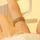 Unazë e hollë e hapur prej çeliku të veshur me ar Troli