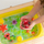 Lodër sensorike Glo Pals Sesame Street Elmo, kube me drita, set 4 copë, të kuqe