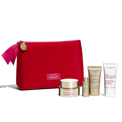 Set Clarins Nutri-Lumiére - krem dite 50 ml + krem nate 15 ml + emulsion 10 ml + krem për duar dhe thonj 30 ml + çantë kozmetike