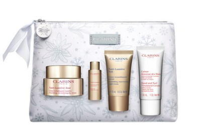 Set krem dite 50 ml + krem nate 15 ml + tretman 10 ml + krem për duar dhe thonj 30 ml + çantë kozmetike Clarins Nutria Lumiere
