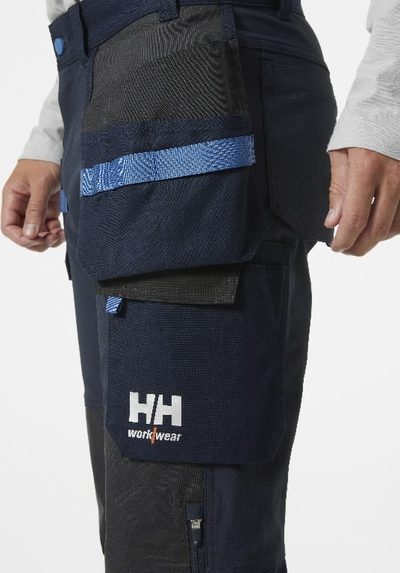 Pantallona pune Helly Hansen Workwear Oxford 4X Stretch, me xhepa t’varur, të përforcuar te gjunjët, blu e errët me të zeza C46